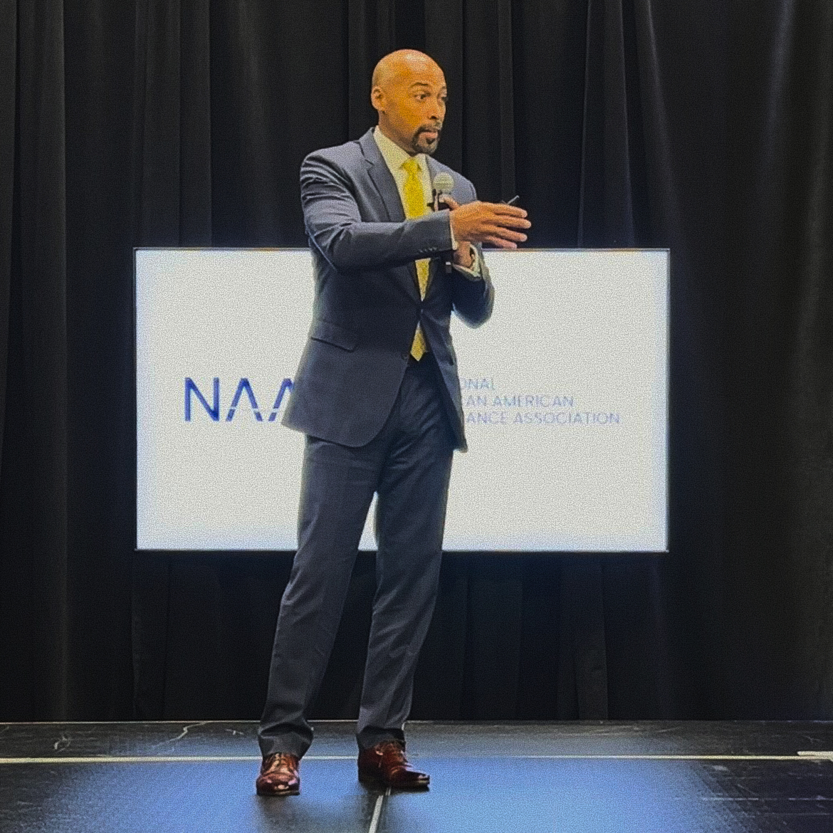 Eugene Mitchell speaking at a NAAIA event